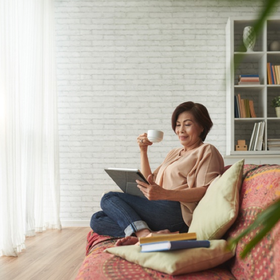 Stock photo of an older woman enjoying coffee in the morning.